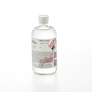 A 480mL clear glass bottle of reagent grade nitric acid by Alchemie Labs with detailed labeling and safety information.