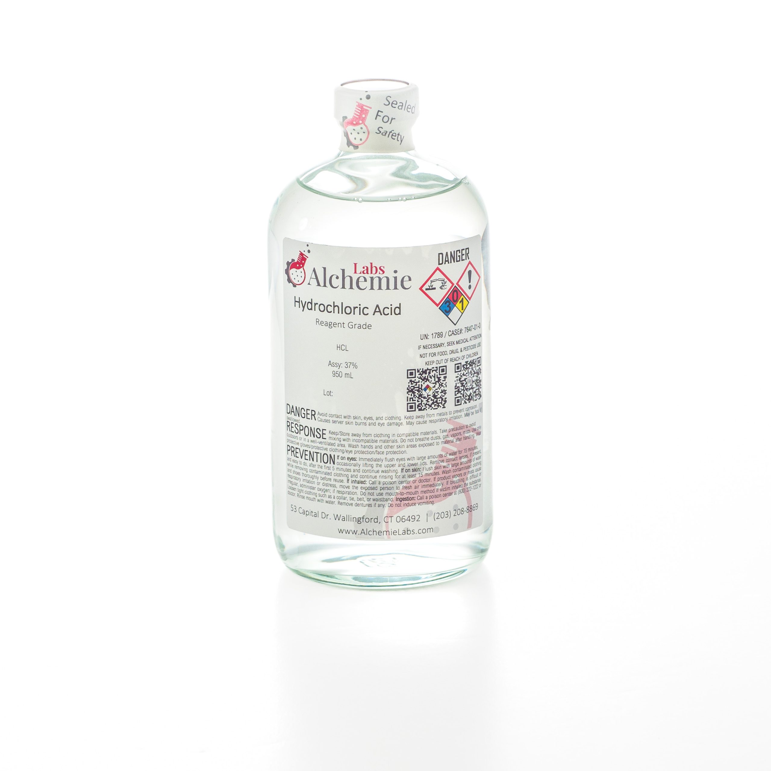 A 950mL clear glass bottle of Alchemie Labs hydrochloric acid, reagent grade, with safety seal and comprehensive labeling.