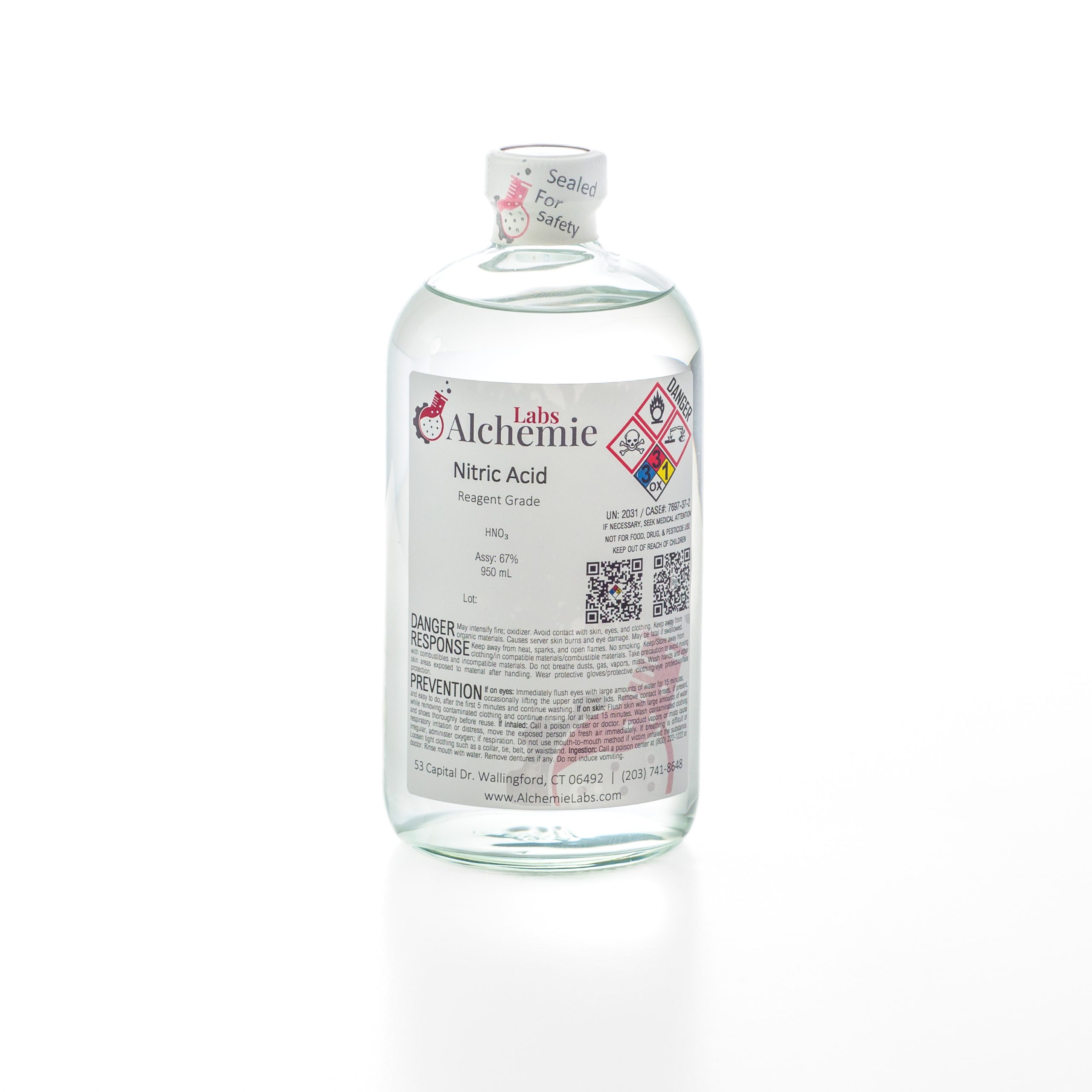 950mL clear glass bottle of Alchemie Labs nitric acid, with reagent grade purity and safety seal intact.