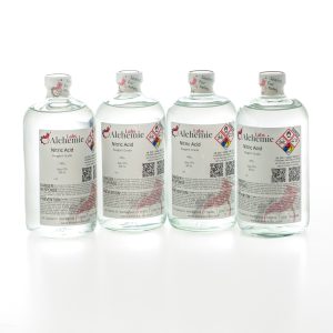 Four 950mL bottles of Alchemie Labs nitric acid, each featuring reagent grade quality and safety seals.