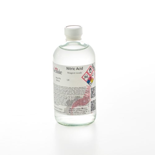 A 480mL clear glass bottle of reagent grade nitric acid by Alchemie Labs with detailed labeling and safety information.