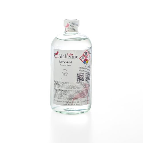 950mL clear glass bottle of Alchemie Labs nitric acid, with reagent grade purity and safety seal intact.