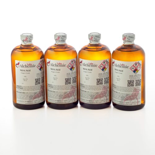 Four 950mL amber bottles of reagent grade nitric acid by Alchemie Labs, each sealed for safety.